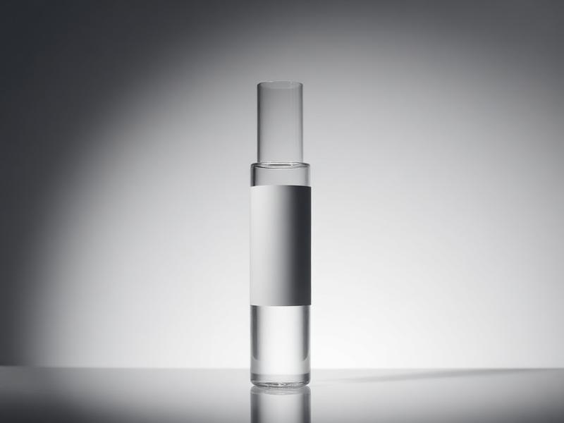 Tall slim clear NAD+ vial with blank label under soft side lighting